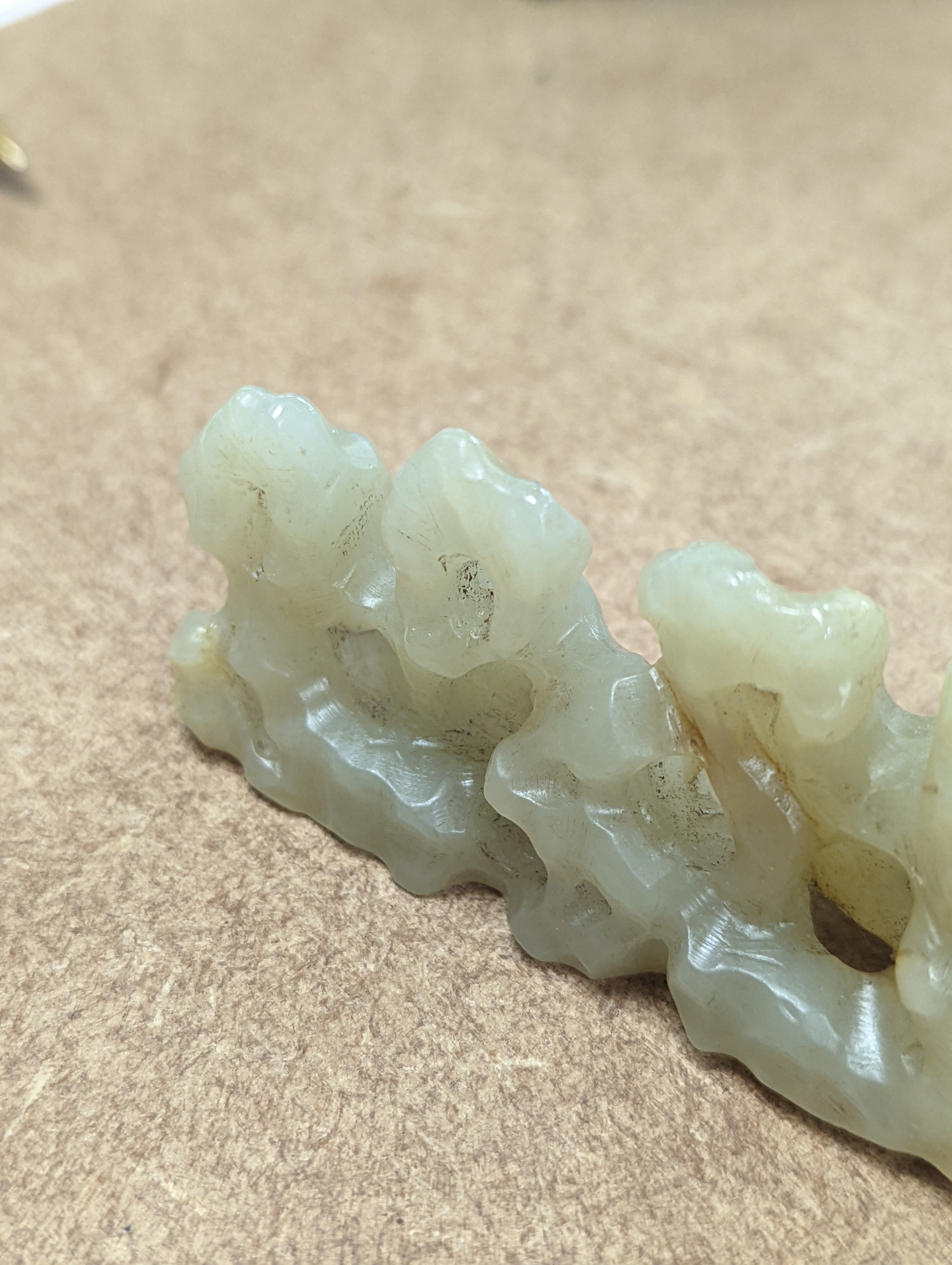 A Chinese celadon jade brush rest, 8cms wide